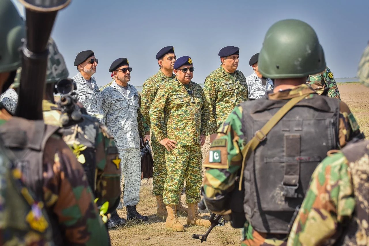 Admiral Naveed Ashraf meeting naval personnel in the field.