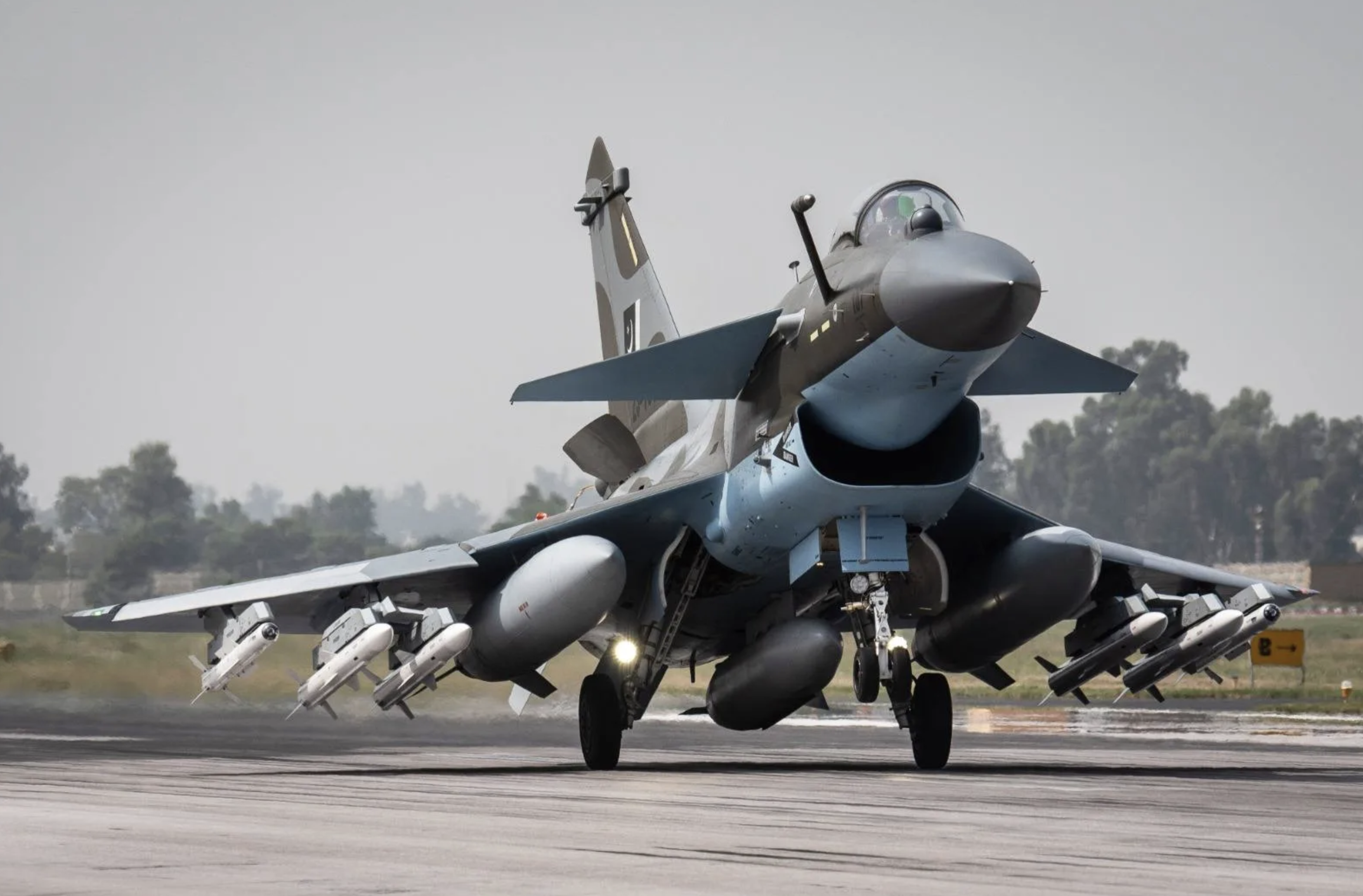 Pakistan Air Force fighter aircraft on a runway, viewed from the front.
