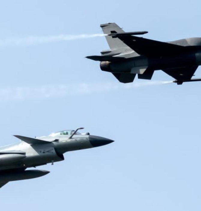 Photo of a fly-by featuring a Pakistani F-16C or D and a Pakistani J-10CE.