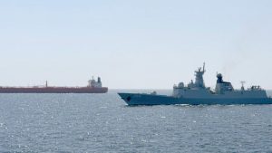 Photo of a Pakistan Navy Type 054A/P frigate escorting a merchant ship.