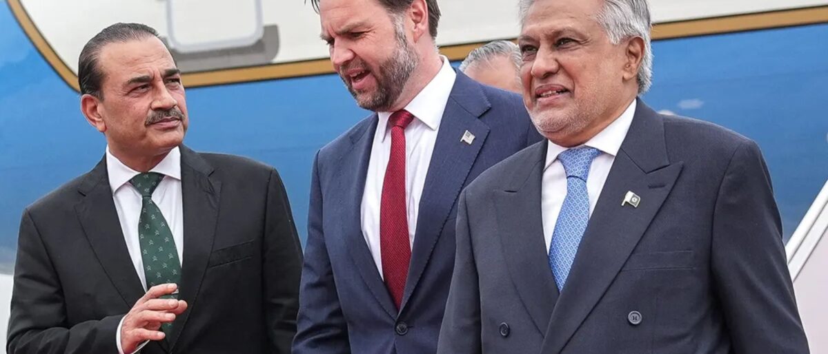 Three men in suits walking together on a tarmac, near a blue airplane in the background, appearing to greet each other at arrival.