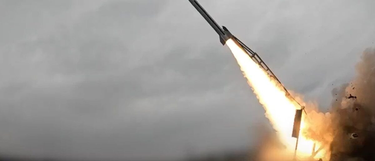 Rocket lifting off from a launch pad with bright exhaust and smoke.