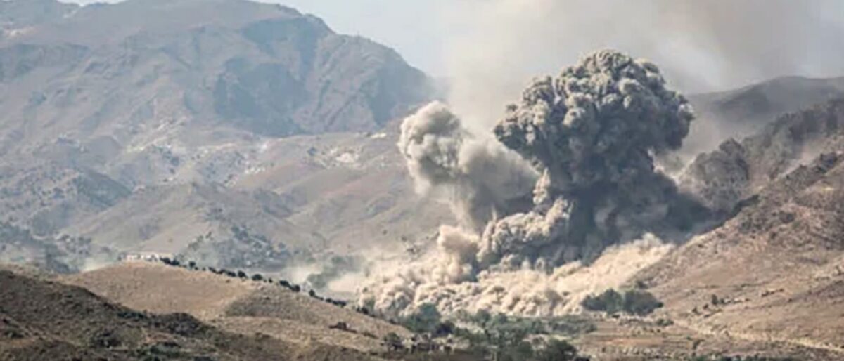 Volcanic eruption in a barren valley, with a large mushroom-shaped ash cloud rising from the crater.