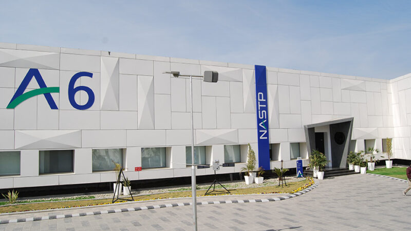 The NASTP "A6" aerospace building at the National Aerospace Science and Technology Park's Alpha cluster, marked with the A6 and NASTP signage, under a clear sky.