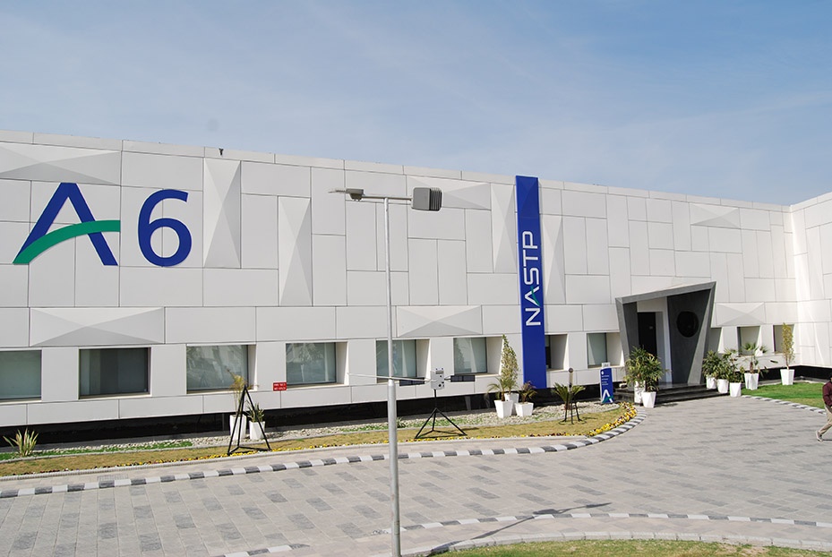 The NASTP "A6" aerospace building at the National Aerospace Science and Technology Park's Alpha cluster, marked with the A6 and NASTP signage, under a clear sky.