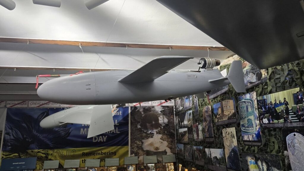 Ukraine's BARS jet-powered missile-drone on display, showing the miniature turbojet engine mounted externally above the tail of the fuselage