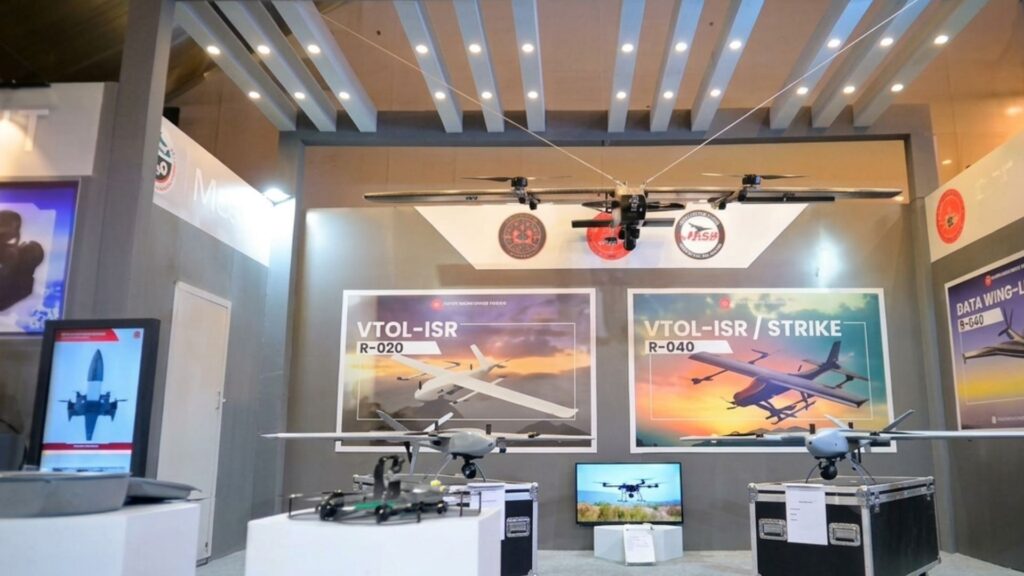 Exhibition booth showcasing VTOL-ISR drones with large posters reading VTOL-ISR and VTOL-ISR/Strike on the back wall.