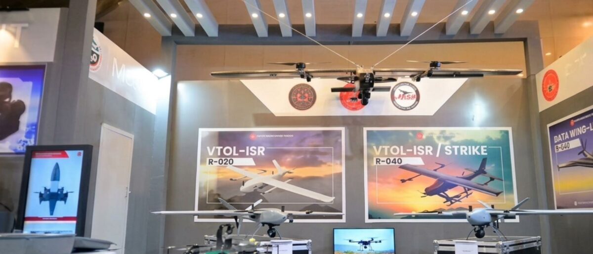 Exhibition booth showcasing VTOL-ISR drones with large posters reading VTOL-ISR and VTOL-ISR/Strike on the back wall.