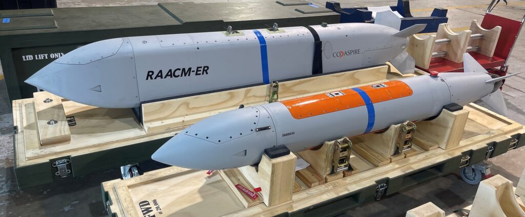 CoAspire RAACM-ER and RAACM low-cost cruise missiles on shipping cradles at a July 2026 flight test event, the design selected by the US Navy for the CHAOS program