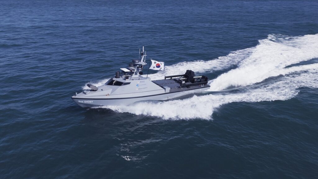 Hanwha Systems' Haeryeong multi-purpose reconnaissance unmanned surface vessel underway at speed, with Sea GHOST lettering on the bow and a Republic of Korea ensign