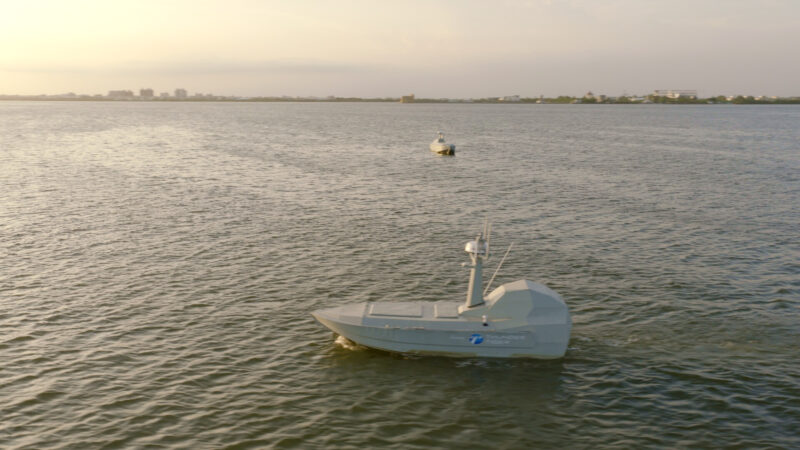 A Thunder Tiger SeaShark unmanned surface vessel underway at Dapeng Bay, Taiwan, with a second vessel in the background, during the Shield AI Hivemind autonomous teaming demonstration