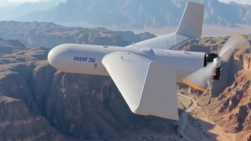 White futuristic unmanned aircraft with a V-tail gliding over a deep canyon landscape.