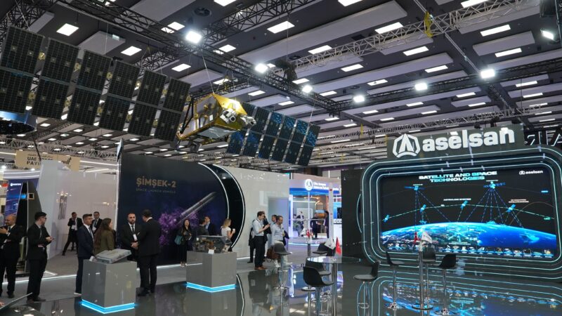 ASELSAN’s IAC 2026 stand with a satellite model and ASTRALINK network display