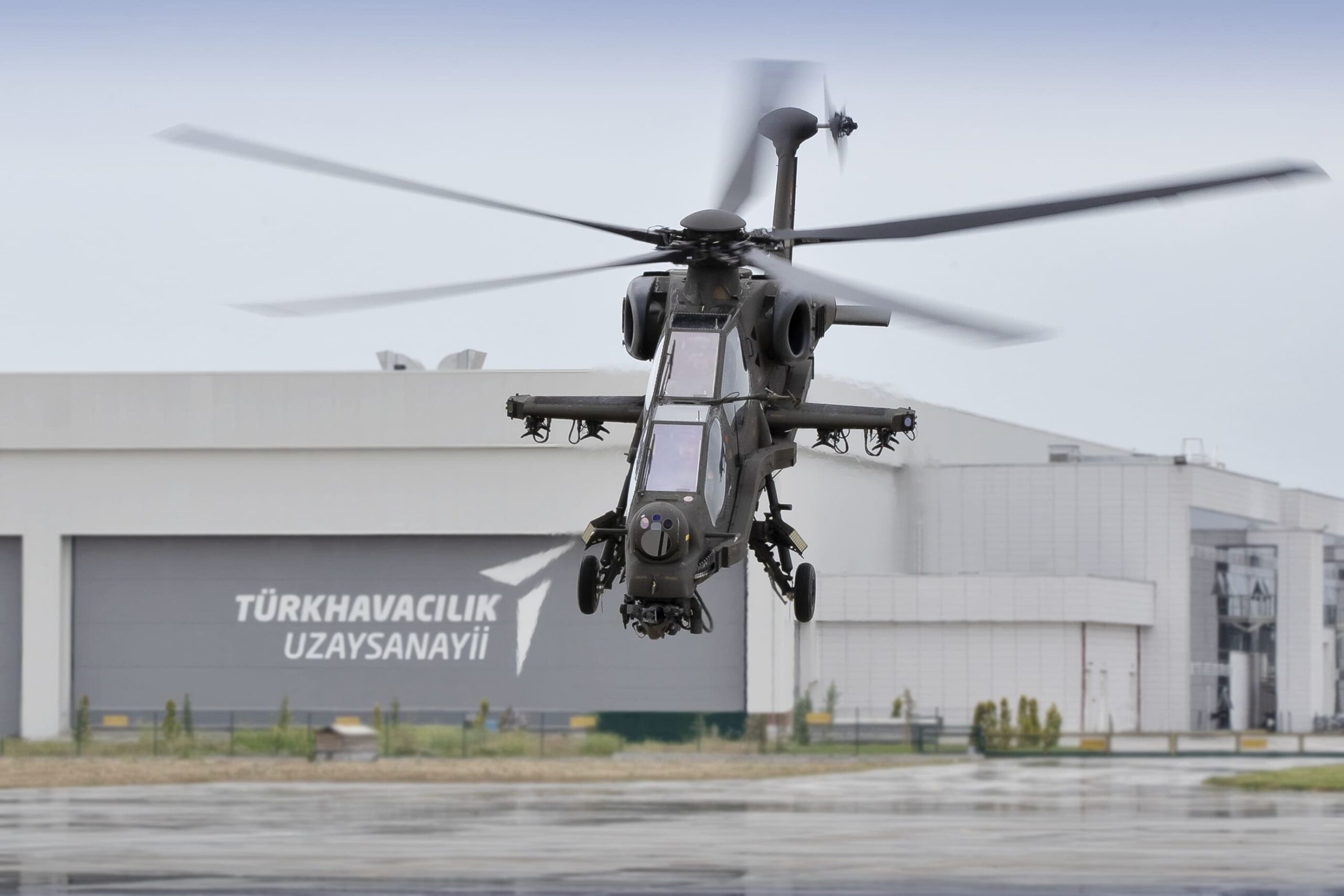 tusas-t129-atak-helicopter-nigeria - Quwa TUSAŞ T129 ATAK attack helicopter hovering in front of a Turkish Aerospace hangar